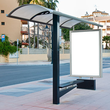 Empty white billboard at bus stop