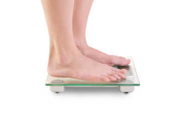 Woman legs on scales.