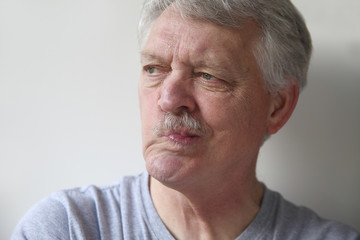 senior man distorts his mouth