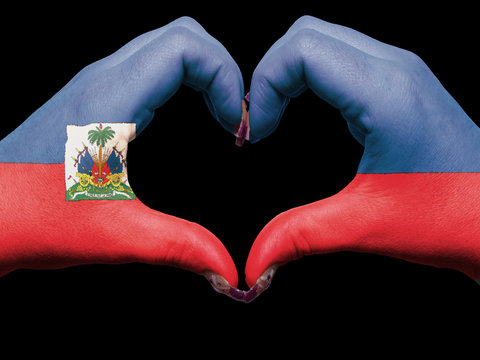 Heart and love gesture by hands colored in haiti flag for touris
