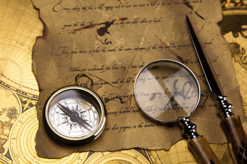 Fototapeta na wymiar Antique brass compass over old paper
