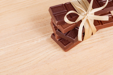 chocolate bars tied with a ribbon on a wooden table