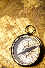 Fototapeta na wymiar Antique brass compass over old map