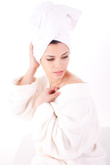 Beautiful healthy young brunette woman in a white spa bath robe