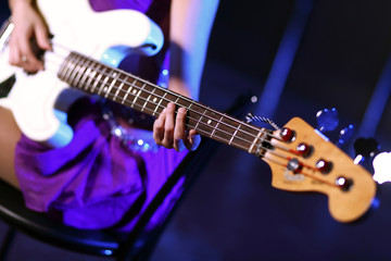 Fototapeta na wymiar Young guitar player performing in night club