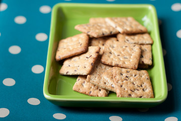 Whole grains biscuits on green plate