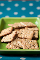 Whole grains biscuits on green plate