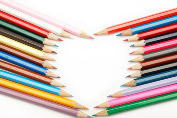 colored pencils crayons composed in the form of heart