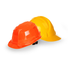 Fototapeta premium Yellow and orange helmets isolated on white background
