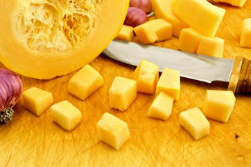 Zucchini yellow on the board with garlic and knife