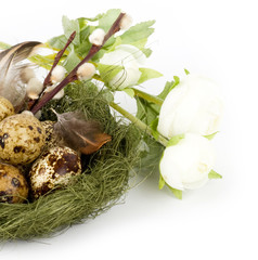 Nest with Easter quail eggs with flowers