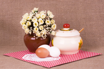 Fototapeta na wymiar Tasty eggs with flowers and jug