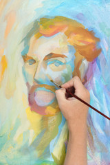 man hand painting multicolored abstract portrait of male
