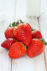 Fresh strawberries and milk bottle