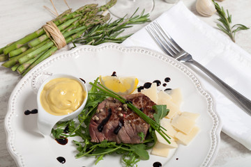 Beef on arugula salad and parmesan