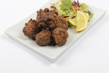 Onion Bhajis served with salad and lemon slices