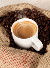 Hot coffee cup on toasted beans