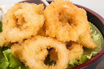 Deep batter fried squid rings calamari with green salad