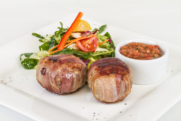 Grilled steak wrapped in bacon, with grilled vegetables, mashed