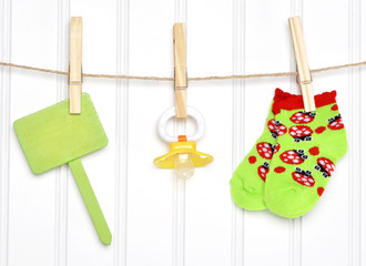 Baby Goods and Blank Sign on a Clothesline
