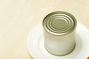 Bank of canned food on a white plate