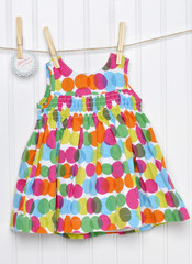 Polka Dot Baby Dress on a Clothesline with Handwritten Sale Sign