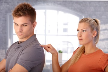 Angry girlfriend poking boyfriend