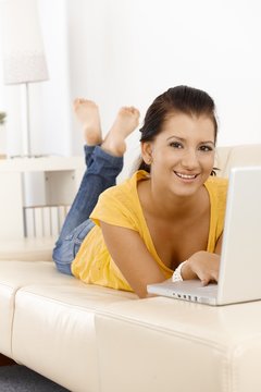 Pretty girl with computer smiling