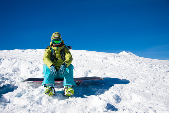 Snowboarder girl sitting
