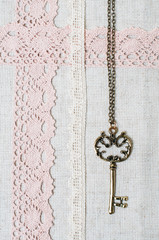 Fototapeta na wymiar key, natural linen fabric and lace