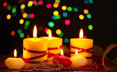 Beautiful candles and decor on wooden table on bright background
