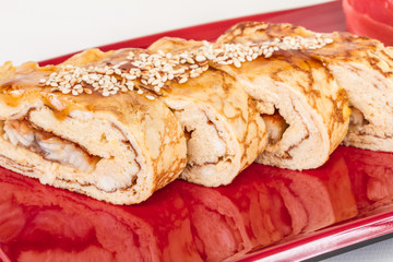 Omelet Maki Sushi - Roll made of Smoked Eel inside. Topped with