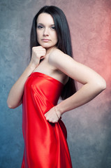 Obraz premium Studio portrait of sensual young woman with long dark hair