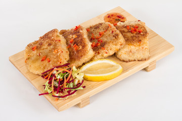 Fried fish fillets with  salad.