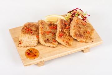 Fried fish fillets with  salad.