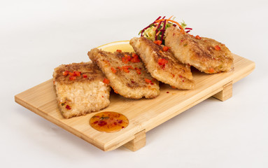 Fried fish fillets with  salad.