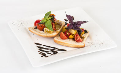 juicy tomatoes on fresh bread, pesto as topping