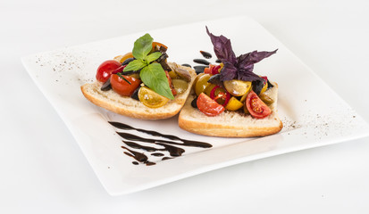 juicy tomatoes on fresh bread, pesto as topping