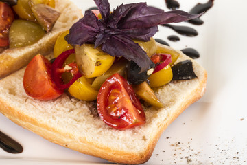 juicy tomatoes on fresh bread, pesto as topping