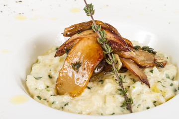 photo of delicious risotto dish with herbs and mushrooms on whit