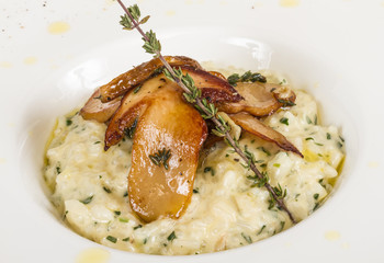 photo of delicious risotto dish with herbs and mushrooms on whit