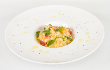 photo of delicious risotto dish with herbs and tomato on white b