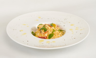 photo of delicious risotto dish with herbs and tomato on white b