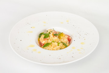 photo of delicious risotto dish with herbs and tomato on white b