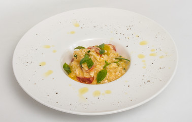 photo of delicious risotto dish with herbs and tomato on white b