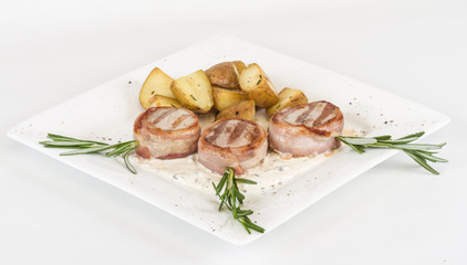 Grilled steak wrapped in bacon, with grilled vegetables, mashed