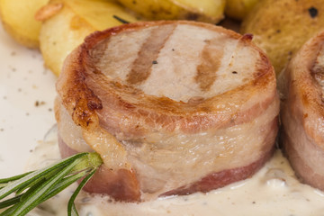 Grilled steak wrapped in bacon, with grilled vegetables, mashed