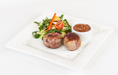Grilled steak wrapped in bacon, with grilled vegetables, mashed