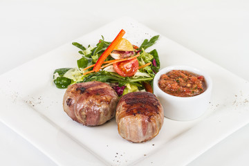 Grilled steak wrapped in bacon, with grilled vegetables, mashed