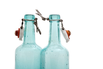 turquoise bottles against white background
